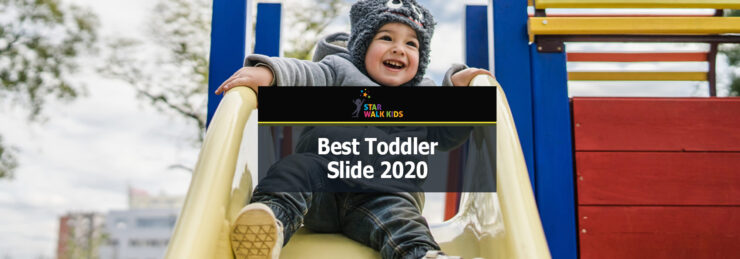 photo of a toddler happily sliding at a kids park