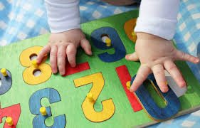 baby playing with baby puzzle with numbers