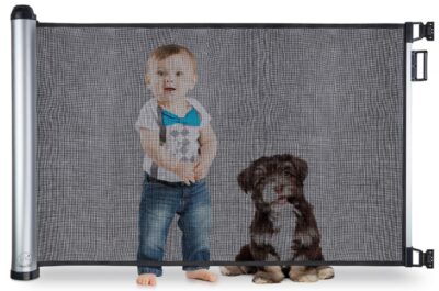 this is an image of a child and a dog behind the new retractable gate for stairs doors and more. 
