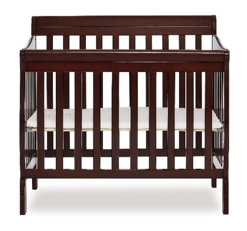 this is an image of a 4 in 1 Aden convertible mini crib for babies. 