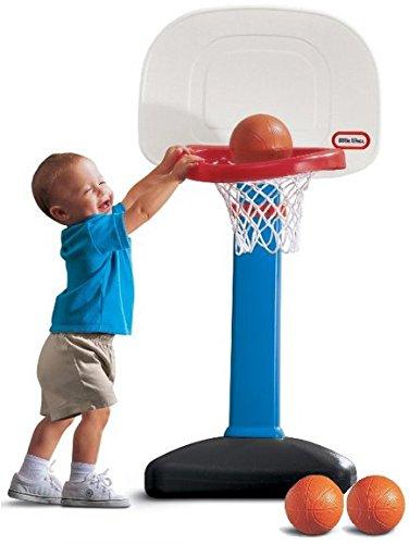 little kid playing with basketball set
