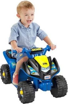This is an image of a child on a batman themed quad bike