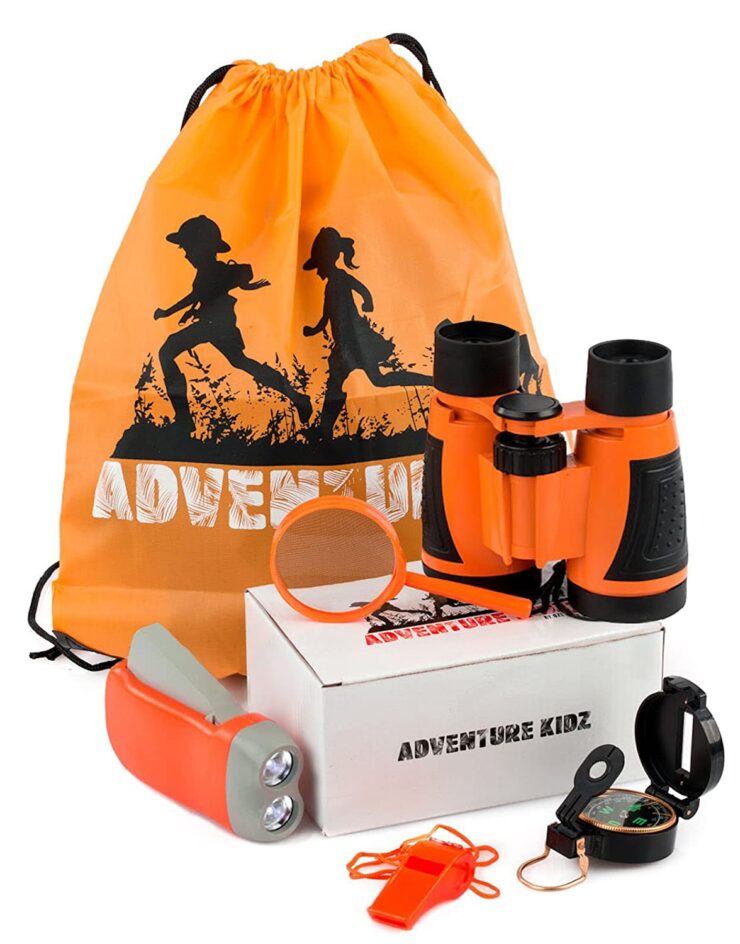 image of an adventure set including a pair of binoculars, a flashlight, a magnifying glass and a drawstring bag in orange hue
