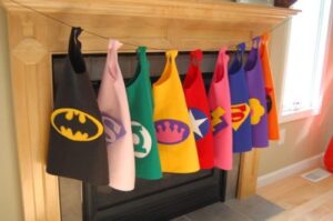 8 different superhero outfits hanging up 