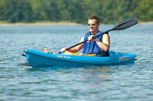 this is an image of a boy paddling on a 8 foot sit on kayak 