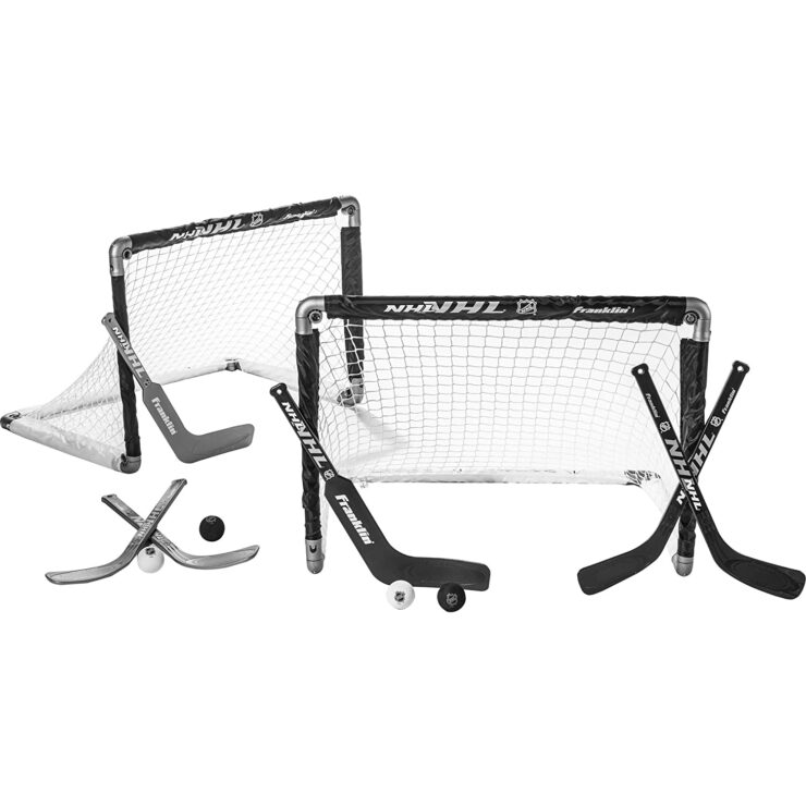A pair of Hockey game set with pucks and sticks in black and white.