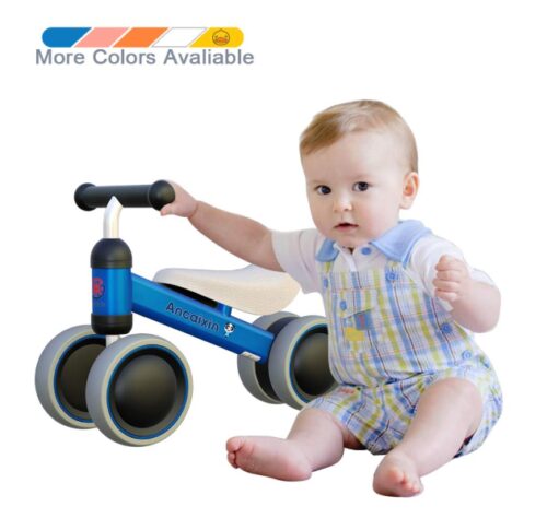 this is an image of a baby holding a blue balance bike.