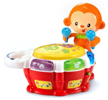 This is an image of a monkey toy beating a drum pad. 
