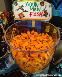 Aqua man fish food tag with party snacks inside a bowl