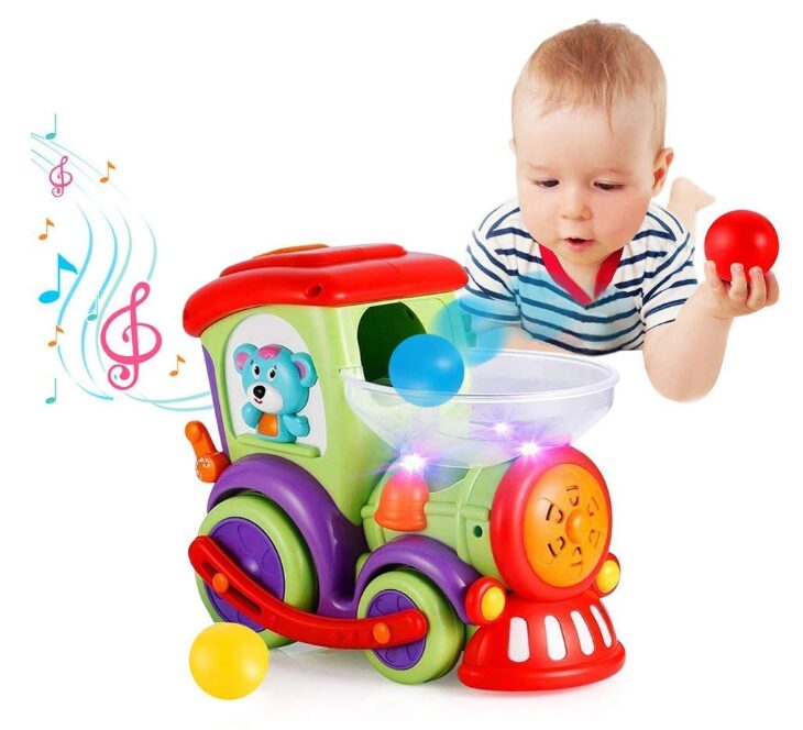 This is an image of a baby playing with a Baby toy car