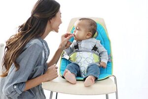 mother and baby. Baby on padded high chair