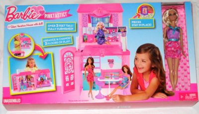 This is an image of a pink vacation barbie house with doll. 