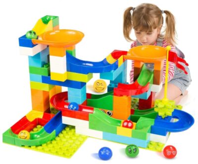 this is an image of a kid playing a 97-piece marble building set. 