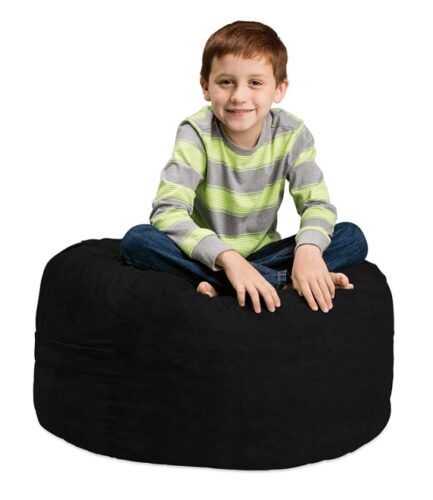 this is an image of a kid sitting in a black bean bag chair. 