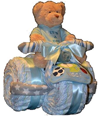 this is an image of a teddy bear riding a tricyle diaper cake for baby boys. 
