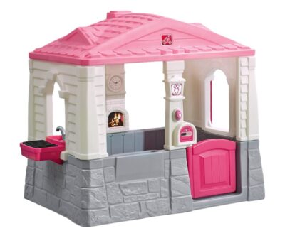 This is an image of a pink cottage and grill playhouse for kids. 