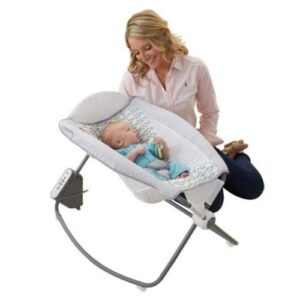 baby with mum next to the Fisher-Price Newborn Bassinet