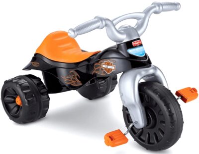 This is an image of boy's harley trike by Fisher and price. black and orange colors