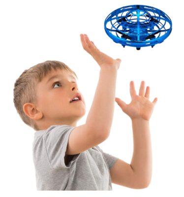 this is an image of a kid playing a hand operated blue drone. 