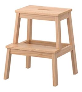 this is an image of a biege wooden step stool. 