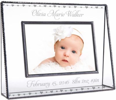 This is an image of a clear glass personalized picture frame for babies.