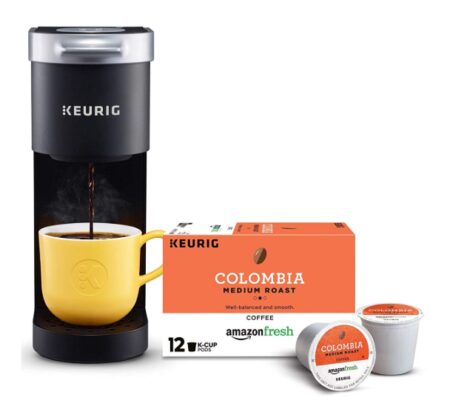 This is an image of a black mini coffee maker with Columbia medium roast coffee pods.