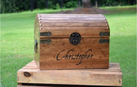 This is an image of kid's personalized wooden treasure chest in brown color