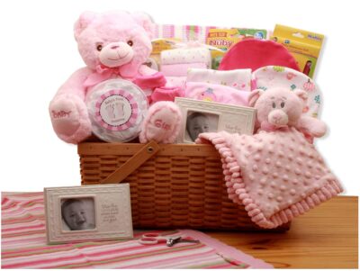 This is an image of baby girl's gift basket in pink color with bear set and other stuff