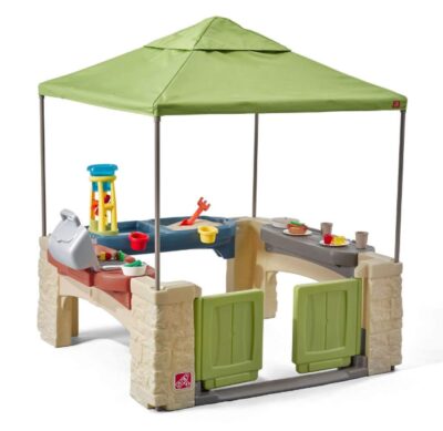 This is an image of a green patio with overhead canopy designed for kids.. 