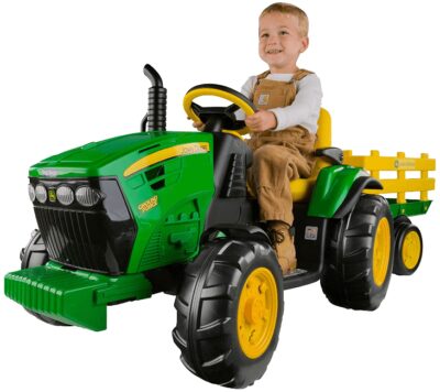 This is an image of boy's tractor with trailer by peg perego. green and yellow colors