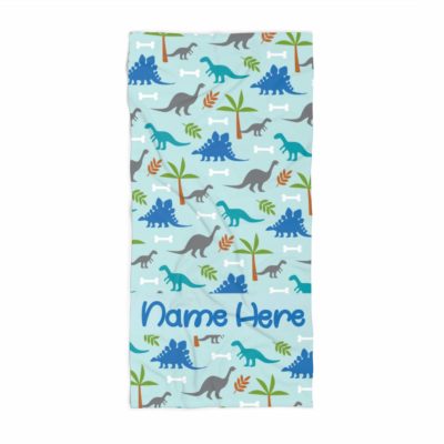 This is an image of a blue personalized towel for kids with dinosaur prints. 