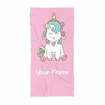 This is an image of a pink personalized towel with unicorn print designed for kids. 