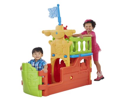 This is an image of kids playing with an outdoor pirate boat playhouse. 