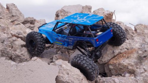 RC car driving up rocks and boulders