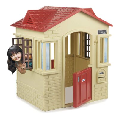 This is an image of a tan cottage playhouse for kids. 