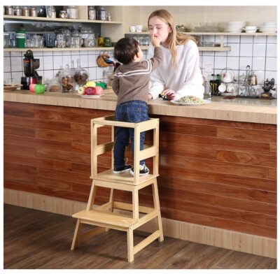 this is an image of a mom and a kid using a kitchen step stool with safety rail. 