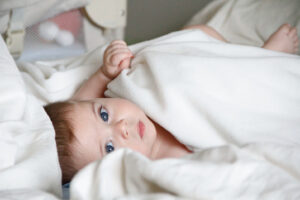 this is an image of a baby lying in a bassinet