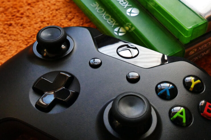 this is an image of an xbox controller with game boxes in the background