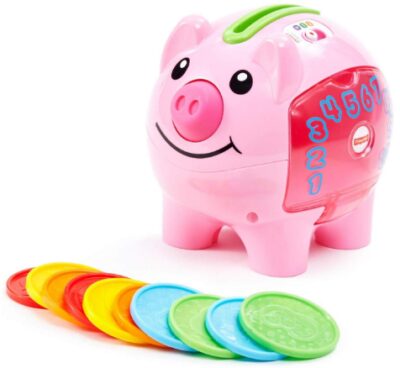 This is an image of toddler's smart piggy bank with coins in pink color