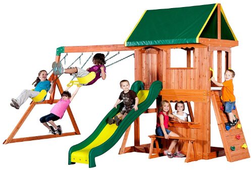 This is an image of swing set with slide and treehouse