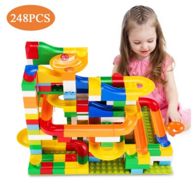  this is an image of a kid playing a 248-piece marble run deluxe set. 