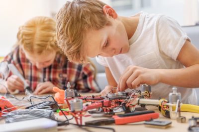 This is an image of 2 boys playing with a drone