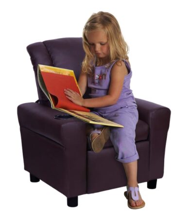 This is an image of a little girl sitting on a brown sofa chair with a cup holder and headrest. 