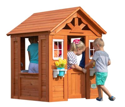 This is an image of kids playing with a wooden playhouse. 