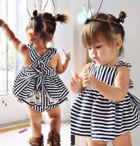 this is an image of a baby with a black and white dress on