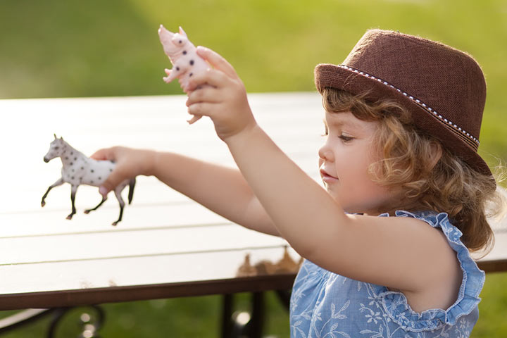 girl playing with farm animals