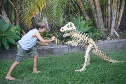 a child fighting a 3d wooden puzzle dinosaur