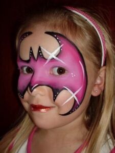 kid girl with her face painted like the bat girl