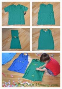 kid kneeling on the floor next to a t shirt cutting with scissors