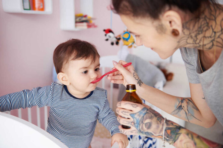 kid taking Cough Syrup